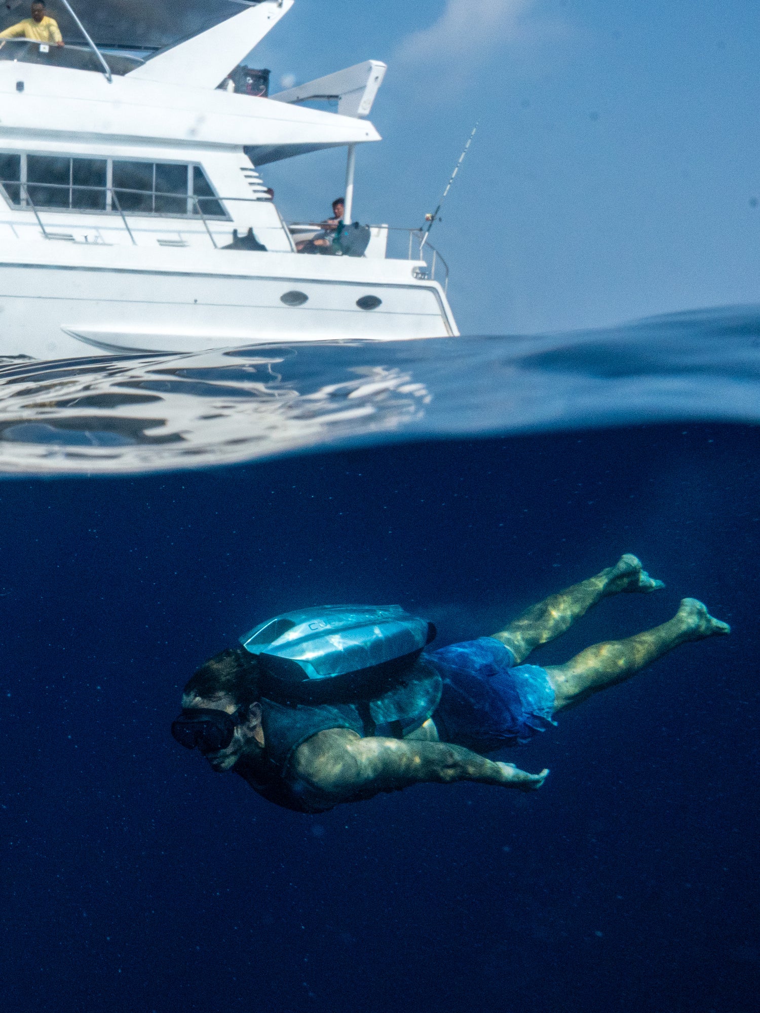Luxury underwater jetpack toy being used beneath a superyacht, designed for high-end water experiences.