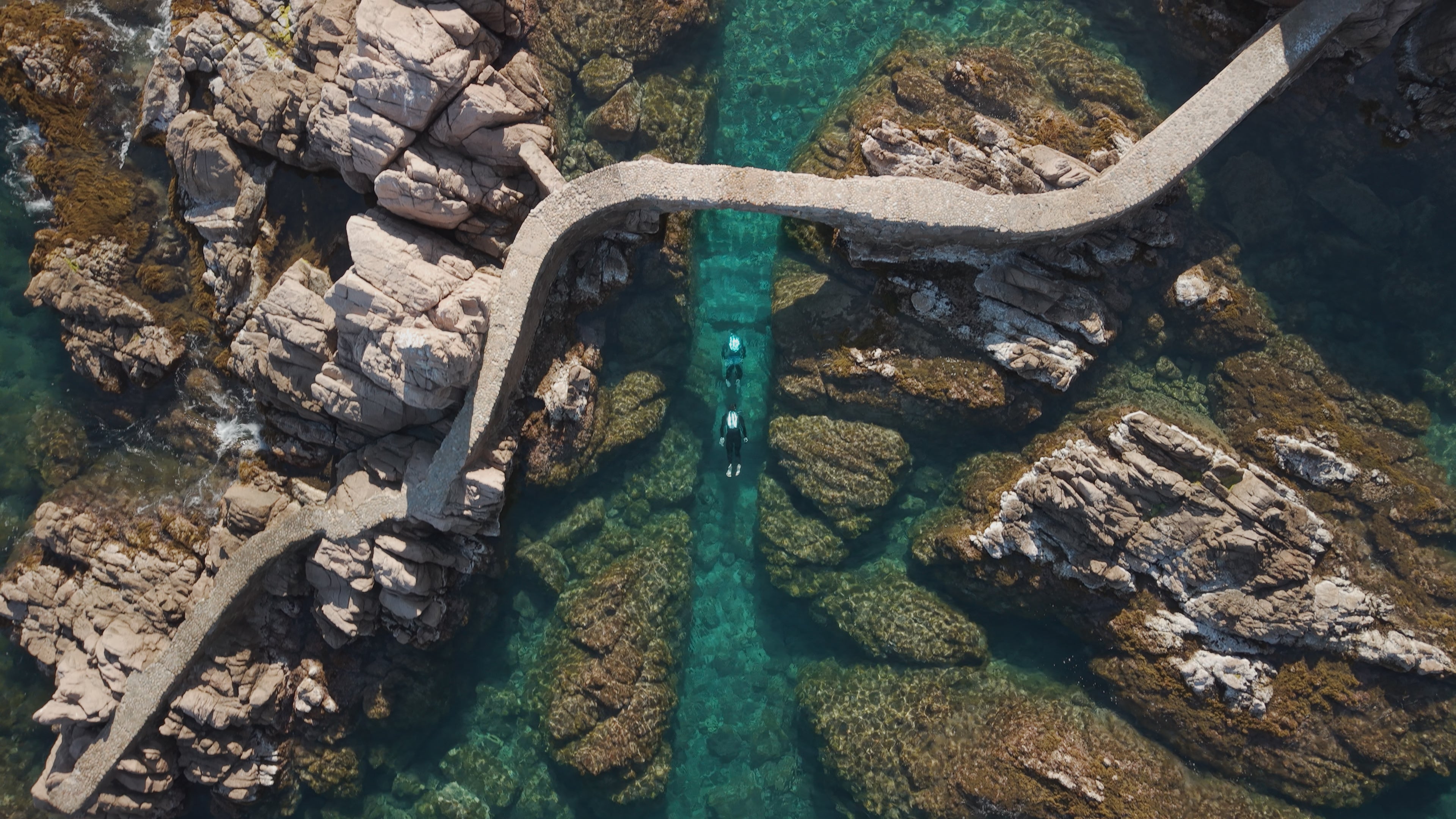 Drone Shot of Underwater Jetpacks Flying Under foot bridge in the Mediterranean