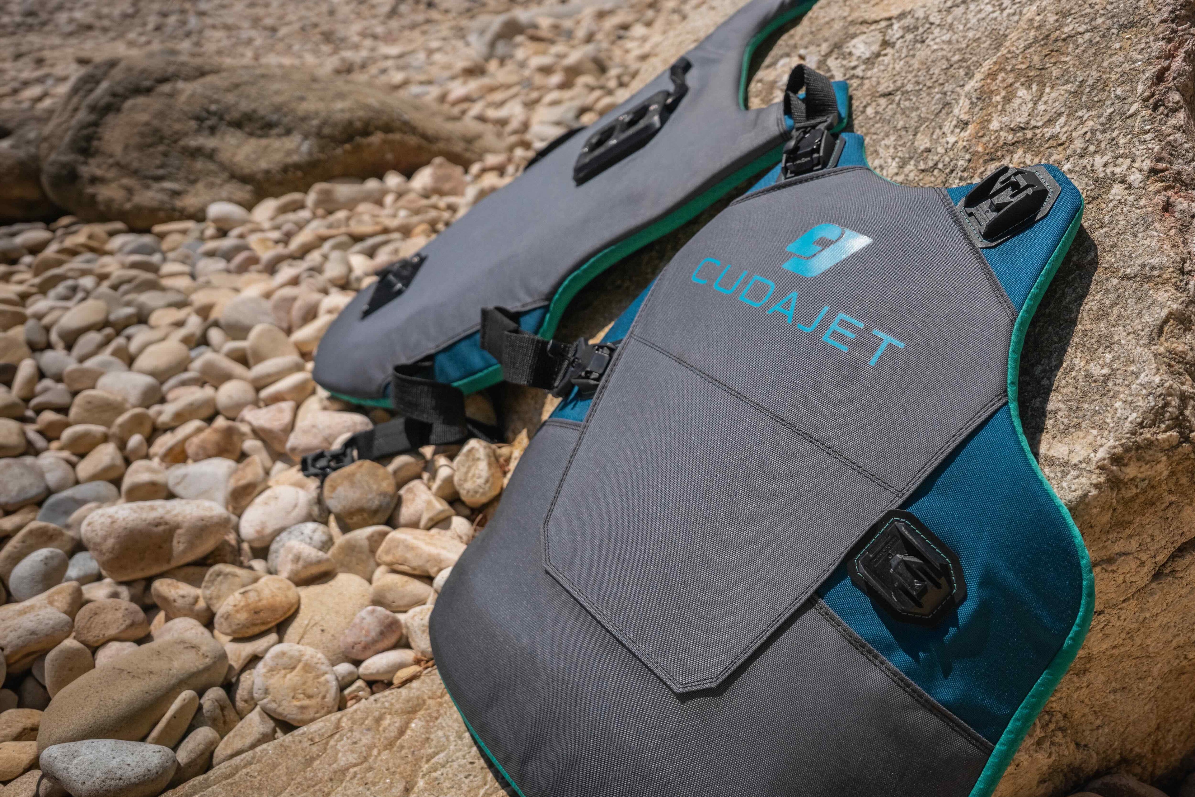 CudaJet harness resting against rocks on a beach