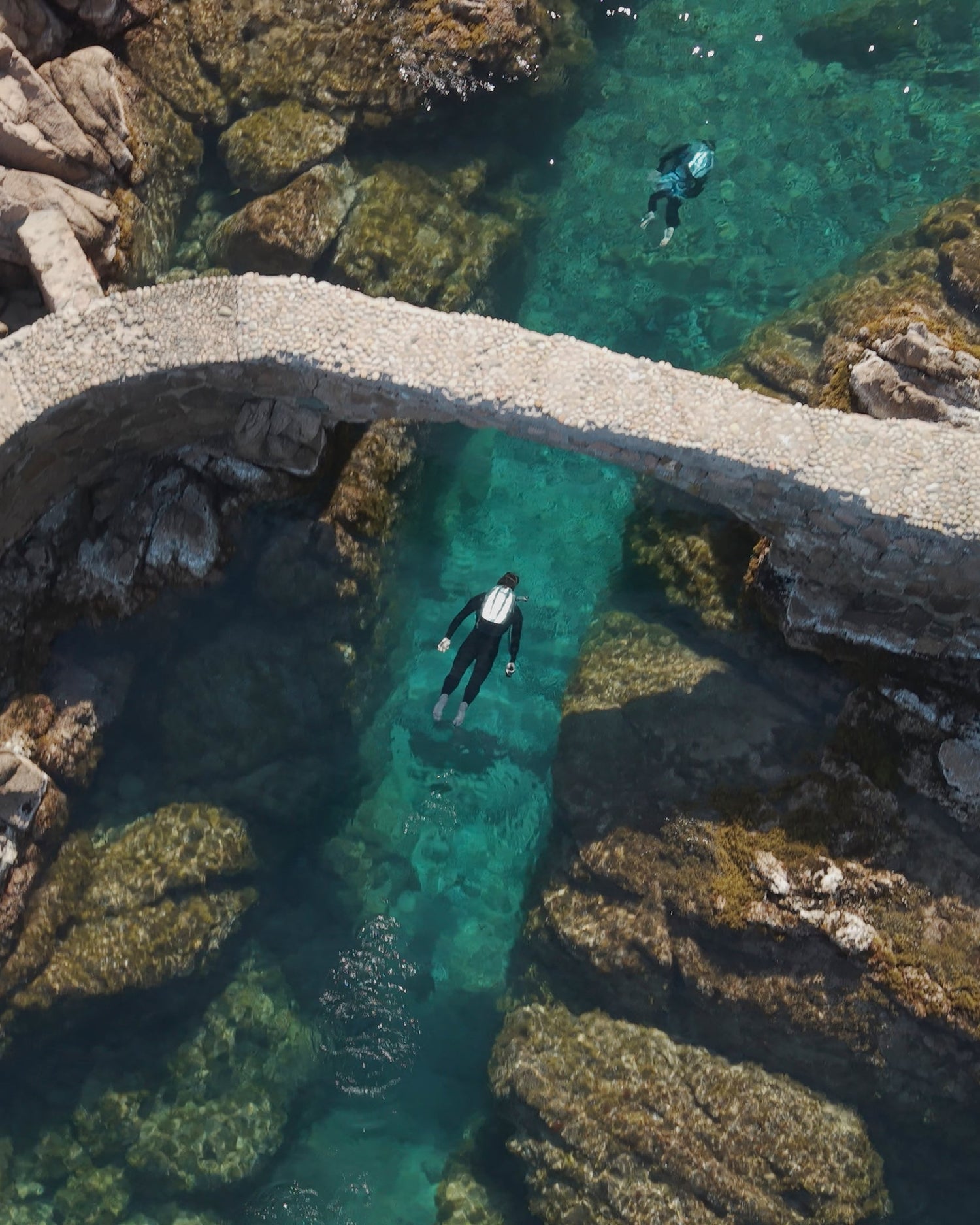 Superyacht toy CudaJet flying udner foot bridge in the Mediterranean